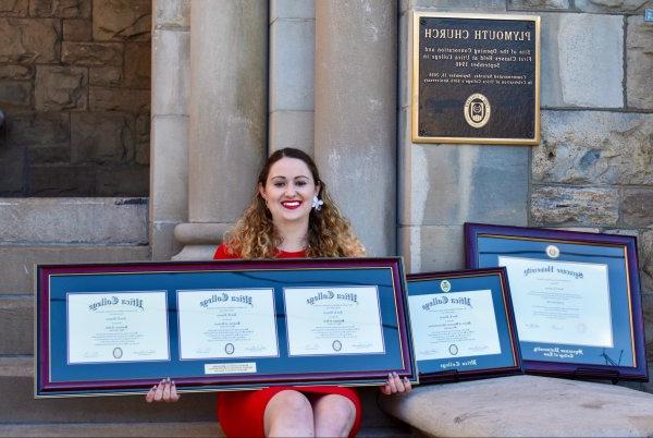 Ann Ciancia sits outside Plymouth Church with her multiple degrees.